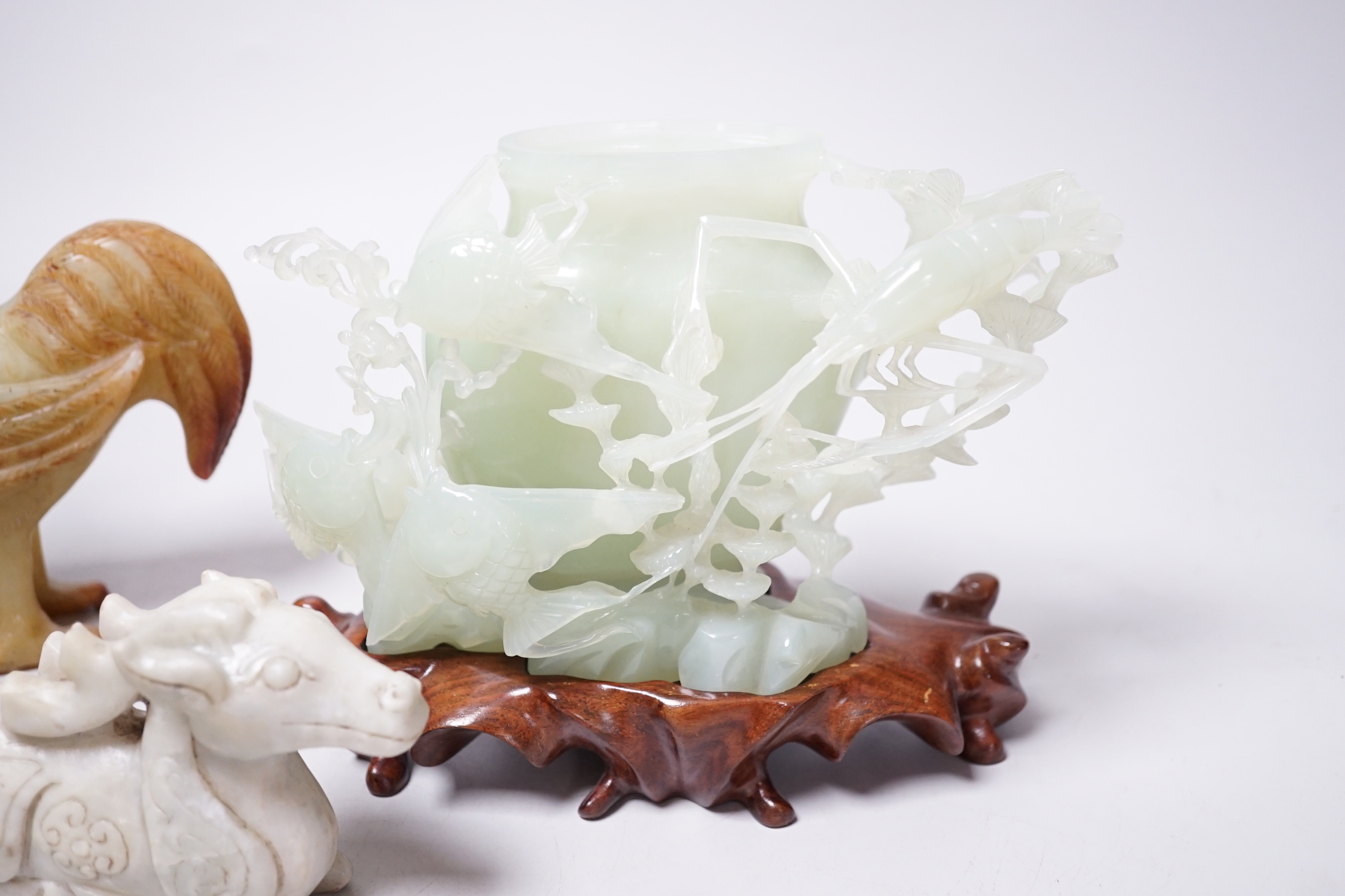 A group of four Chinese bowenite jade and hardstone carvings, the ‘sea creatures’ vase and cover, 18 cm high excluding wood stand